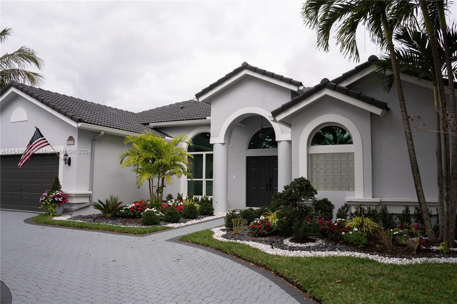 10159 Umberland Place Boca Raton, FL 33428 - Photo 3 of 25 a front view of house with a garden