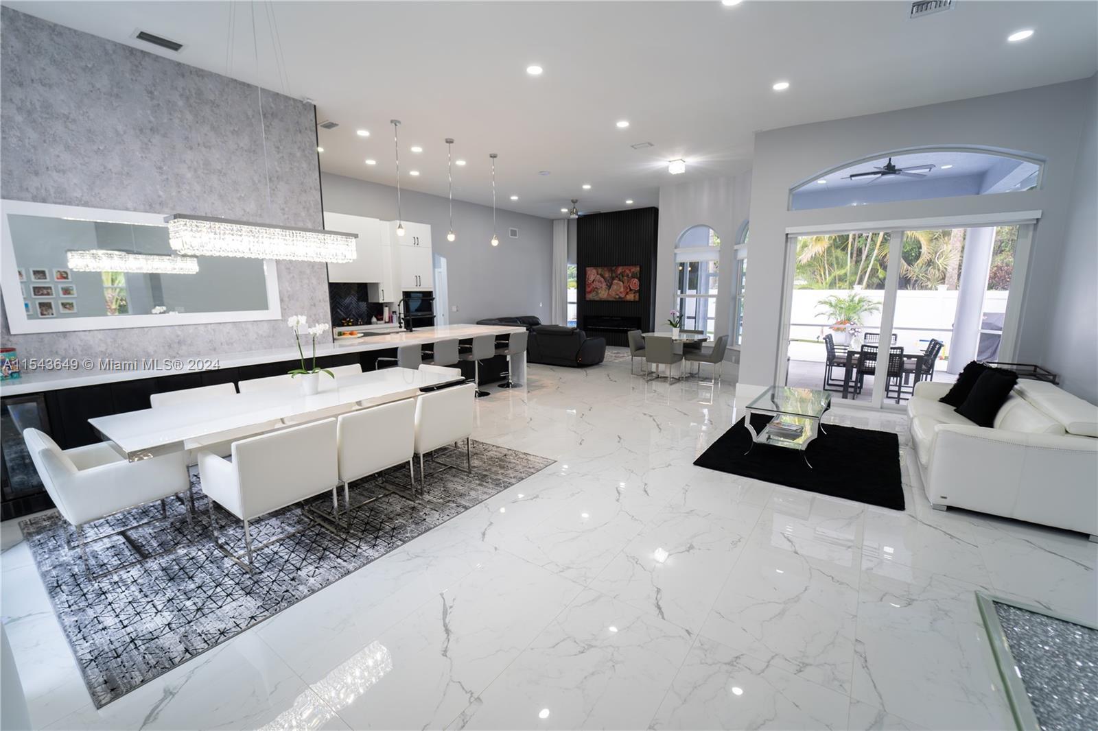 10159 Umberland Place Boca Raton, FL 33428 - Photo 6 of 25 a large white kitchen with a large window