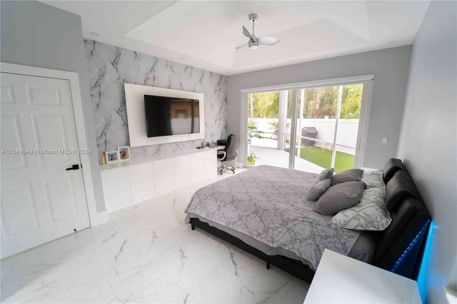 10159 Umberland Place Boca Raton, FL 33428 - Photo 8 of 25 a bedroom with a bed and a flat tv screen