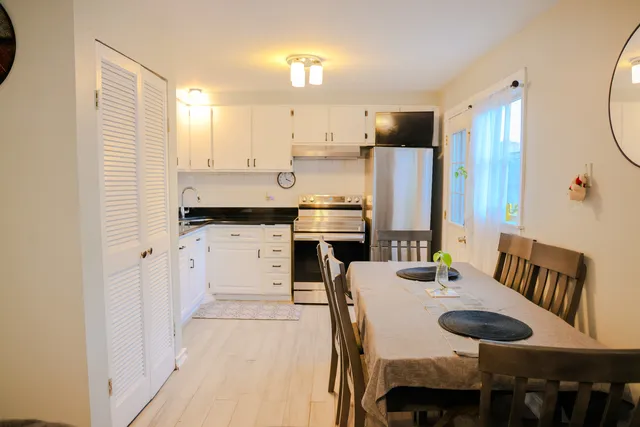 a large kitchen with a table and chairs