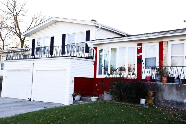 a front view of a house with a yard and outdoor seating