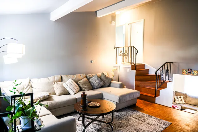 a living room with furniture and wooden floor