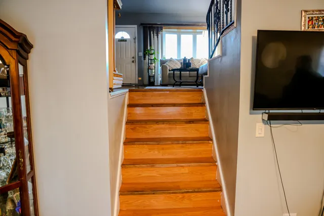 a view of staircase with white walls and a painting on the wall