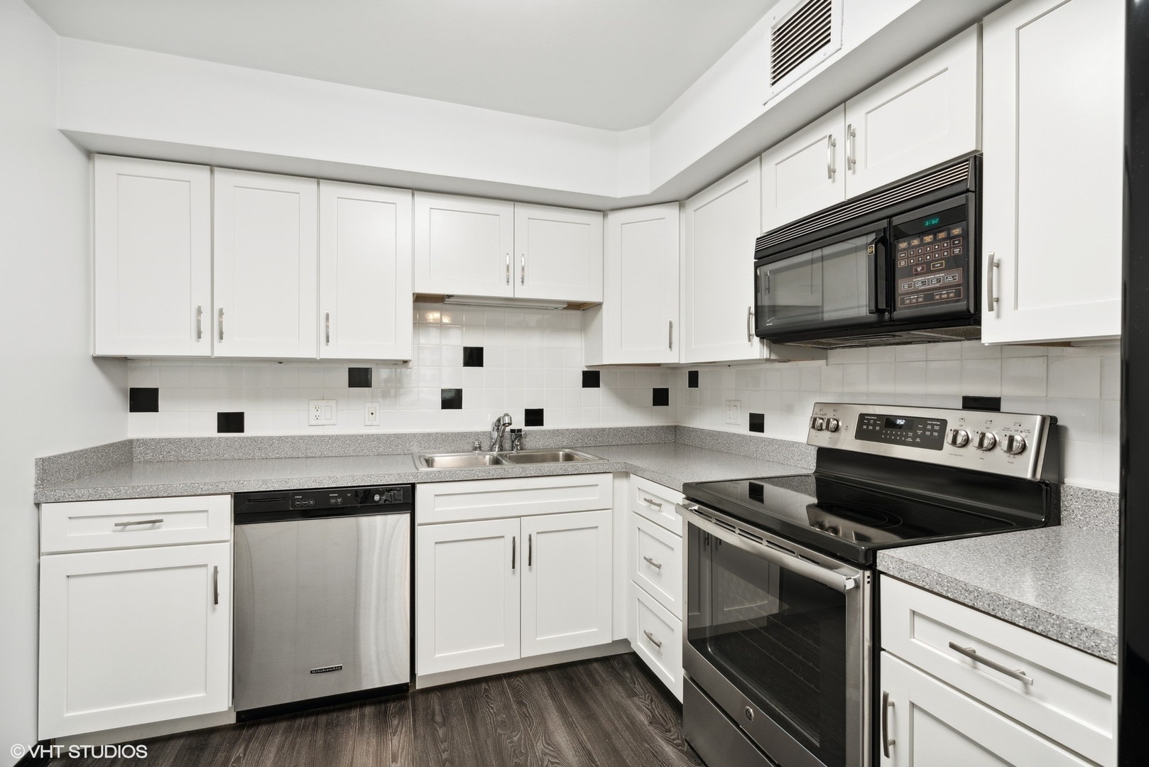 201 East Chestnut Street, Unit 10E Chicago, IL 60611 - Photo 4 of 12 a kitchen with cabinets stainless steel appliances and a sink