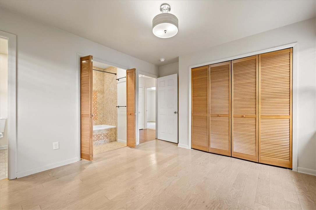 16 State Rd S-23-429 Greenville, SC 29609 - Photo 13 of 34 Gleaming hardwood floors and classic louvered closet doors define this comfortable bedroom suite.