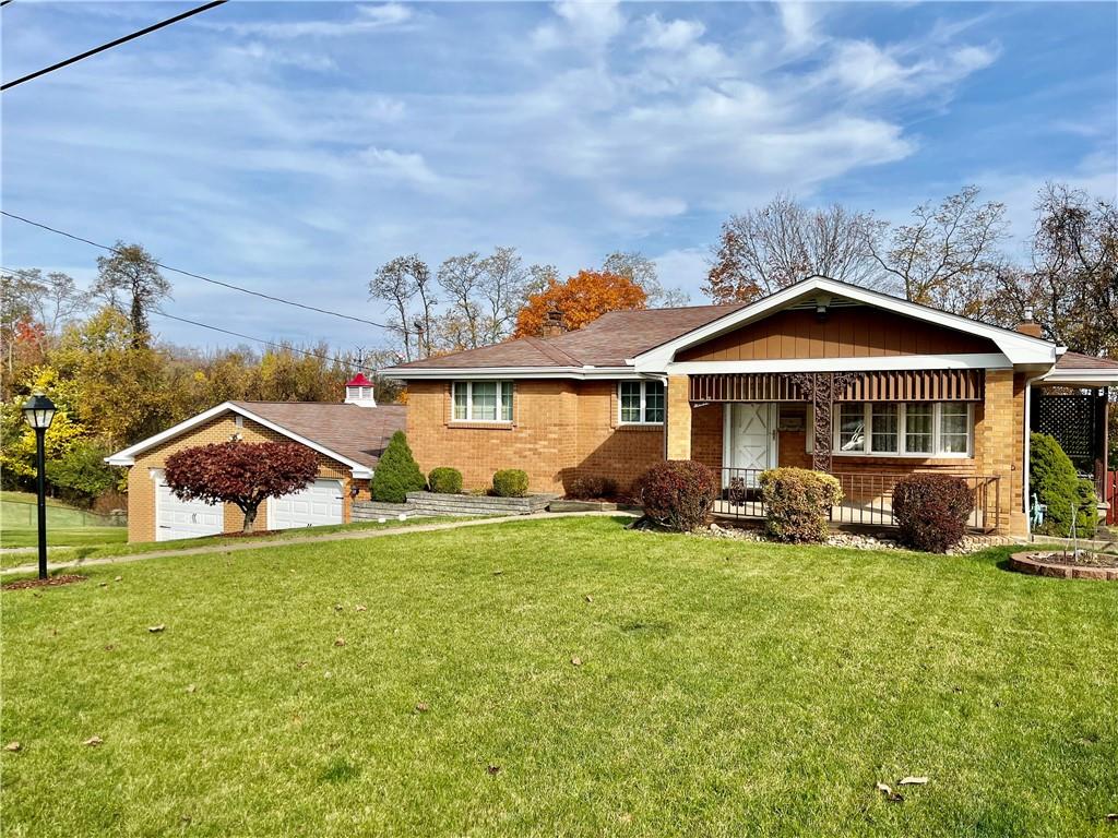1291 Marcia Drive Irwin, PA 15642 - Photo 1 of 32 a front view of a house with a yard