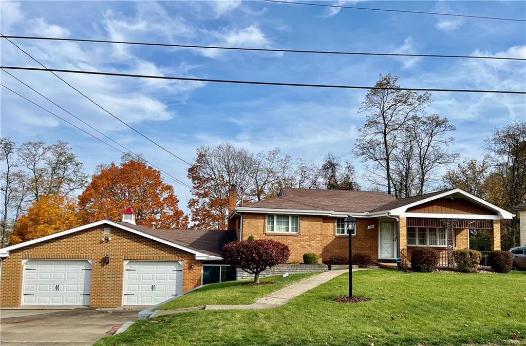1291 Marcia Drive Irwin, PA 15642 - Photo 24 of 32 a front view of a house with a yard and garage