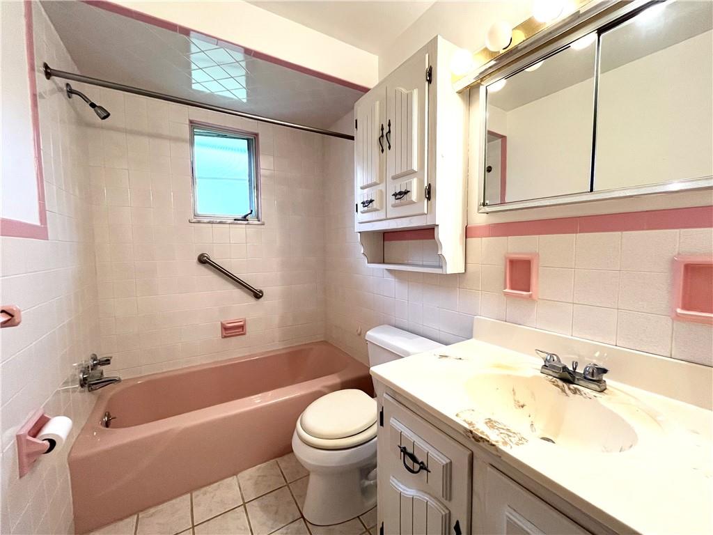 1291 Marcia Drive Irwin, PA 15642 - Photo 28 of 32 a bathroom with a granite countertop sink toilet and shower