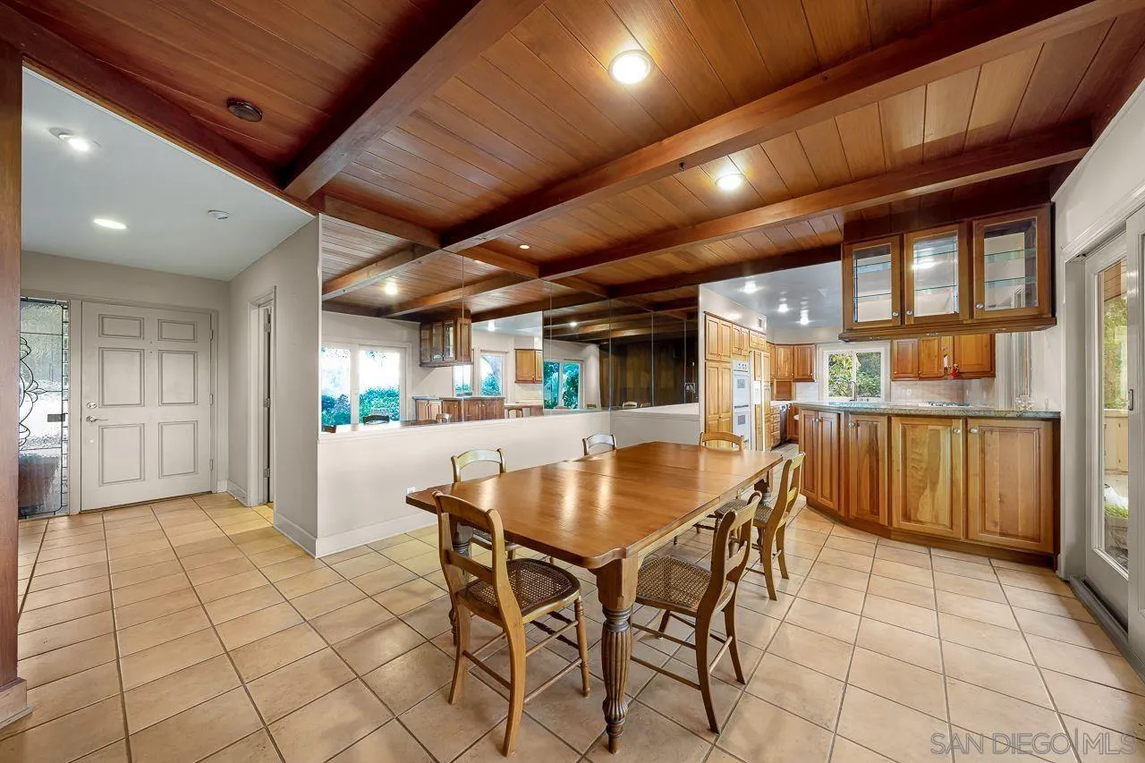 4380 Mayapan Drive El Cajon, CA 92020 - Photo 16 of 52 a dining room with stainless steel appliances kitchen island granite countertop a table chairs and a refrigerator