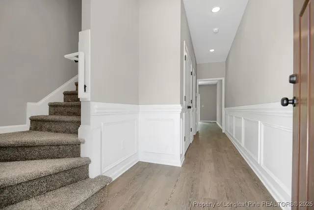 a view of entryway and hall with wooden floor