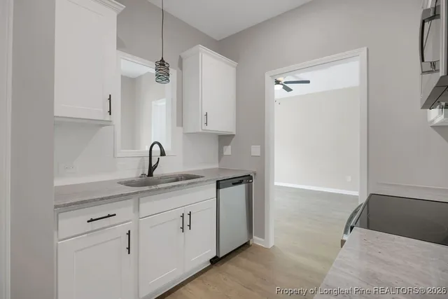 a kitchen with a sink and cabinets