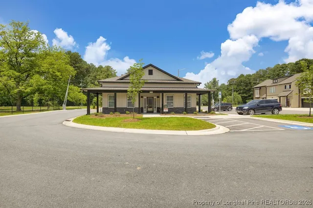 a view of house with swimming pool outdoor seating