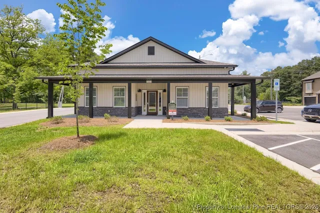 a swimming pool with outdoor seating and yard