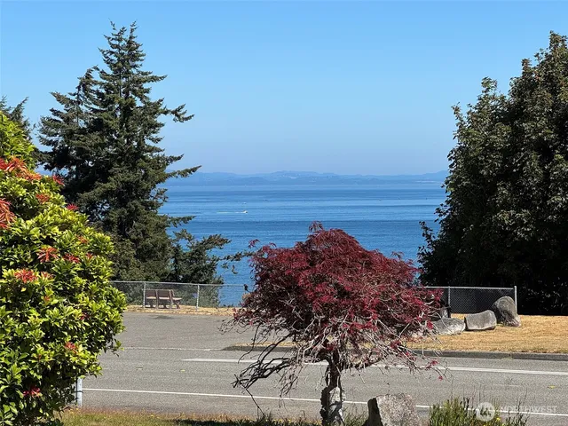 a view of a large body of water with a building in the background