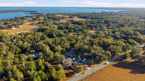 an aerial view of a house with a big yard