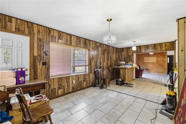 a view of living room kitchen and entryway