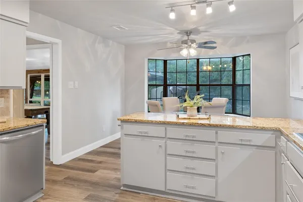 a view of center island cabinets and chandelier