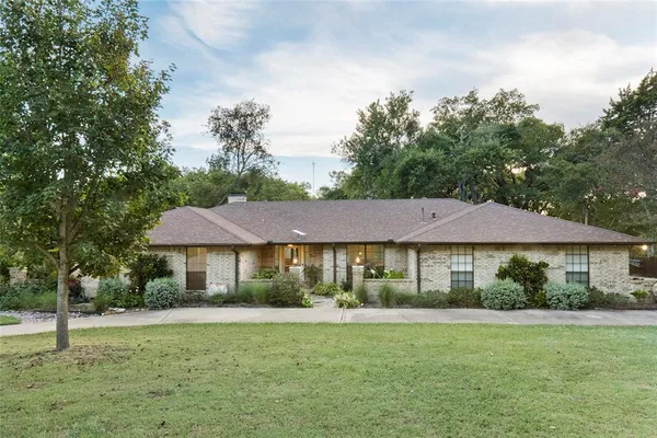 a backyard of a house with table and chairs