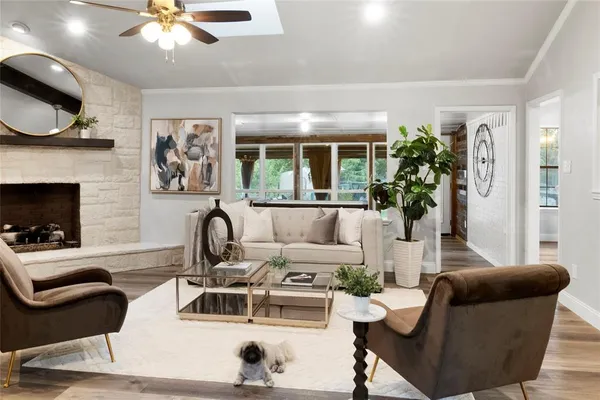 a living room with furniture a chandelier and a fireplace