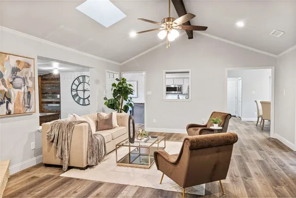 a living room with furniture and a chandelier