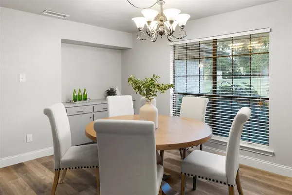 a dining room with furniture and window