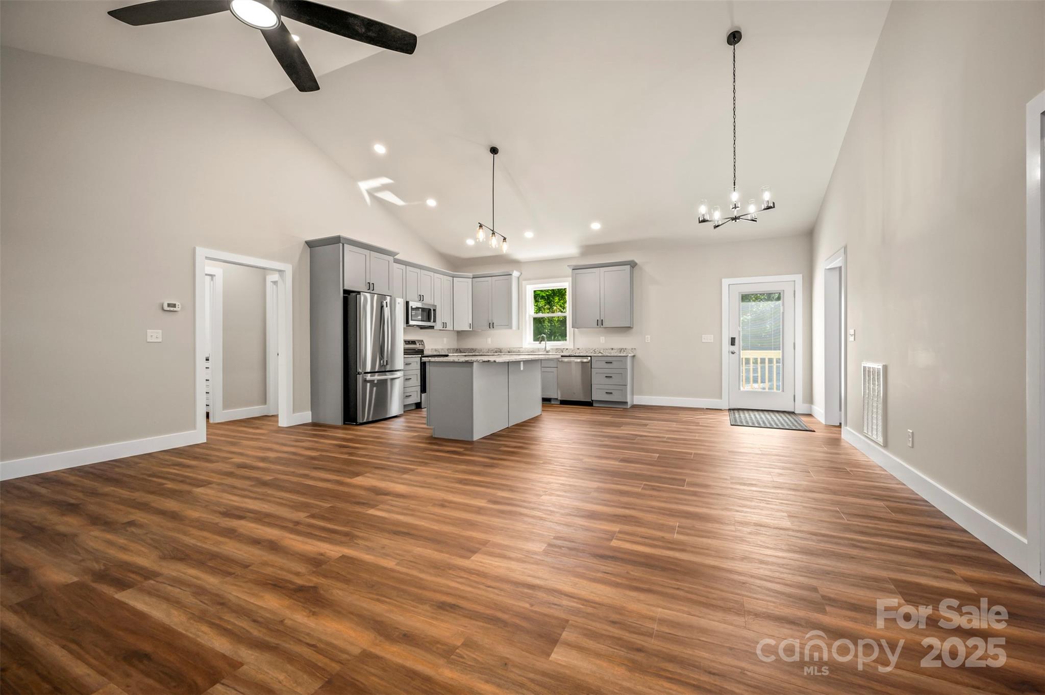 213 Calhoun Street Hendersonville, NC 28739 - Photo 15 of 32 a view of a kitchen with a dishwasher kitchen island wooden floor and ceiling fan