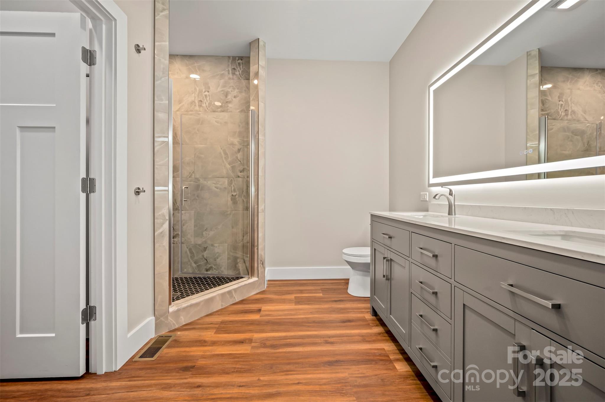 213 Calhoun Street Hendersonville, NC 28739 - Photo 18 of 32 a spacious bathroom with double vanity and mirrors