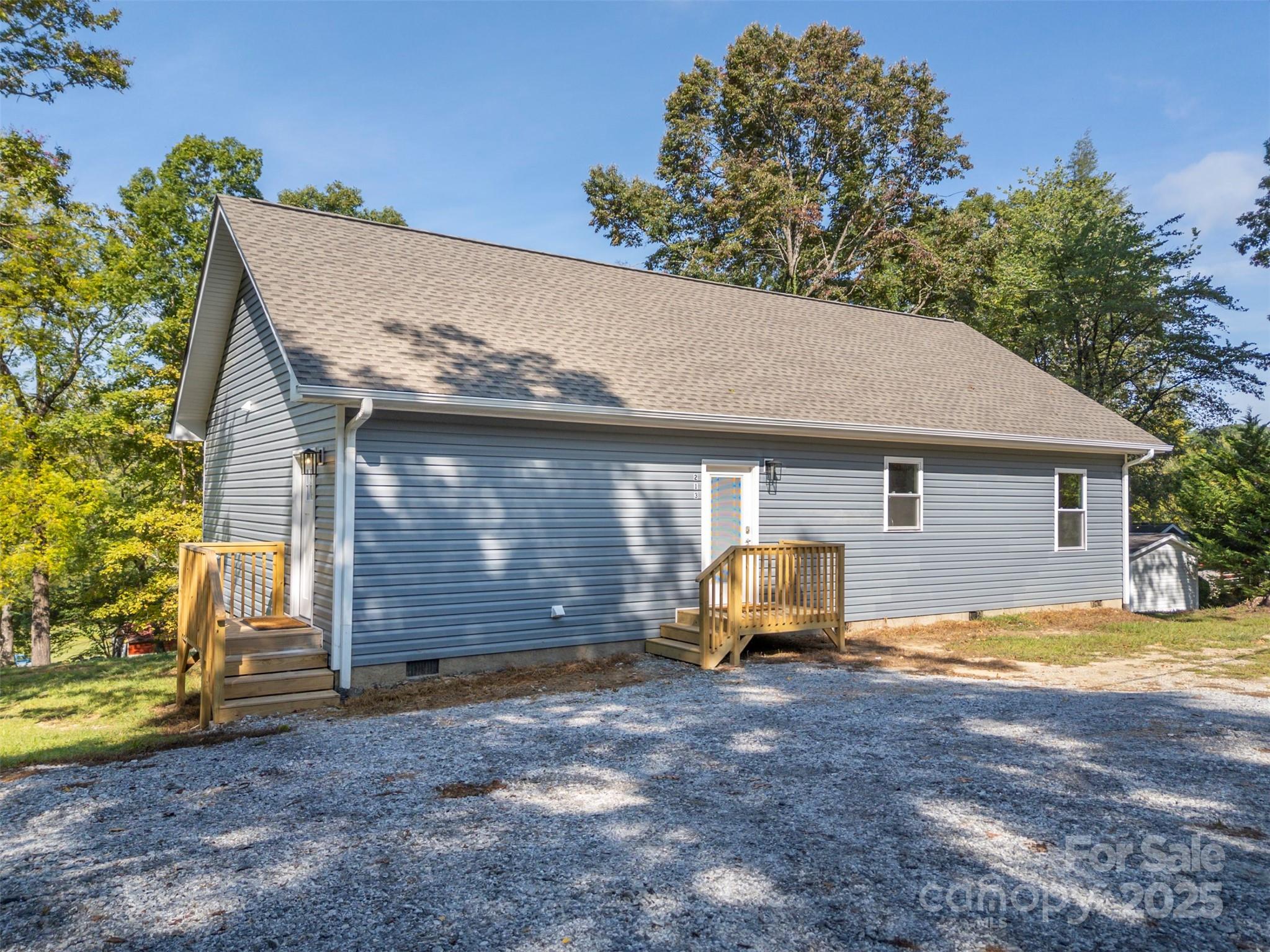 213 Calhoun Street Hendersonville, NC 28739 - Photo 28 of 32 a view of a house with backyard and trees