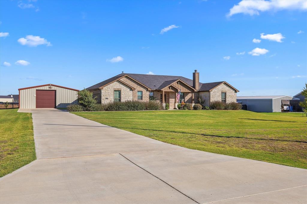 2375 County Road 4010 Decatur, TX 76234 - Photo 2 of 34 View of front facade featuring an outbuilding, a chimney, a front lawn, a garage, and concrete driveway