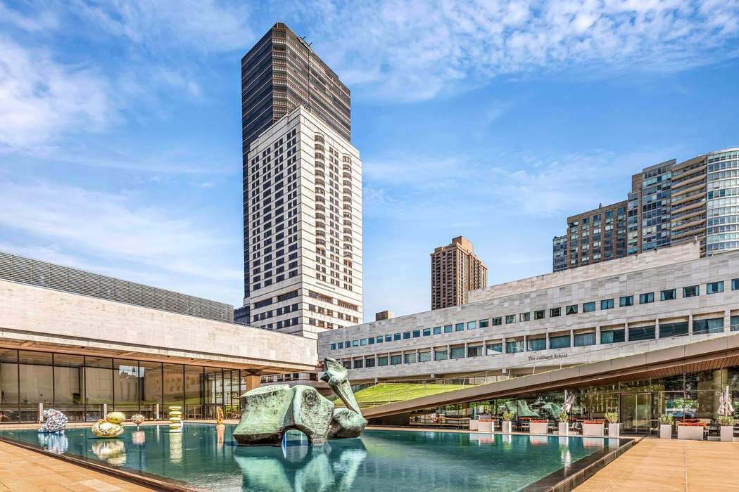 165 West 66th Street, Unit 3R Manhattan, NY 10023 - Photo 7 of 11 a large building with a large window and palm trees