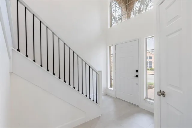 a view of a hallway with wooden floor and entryway