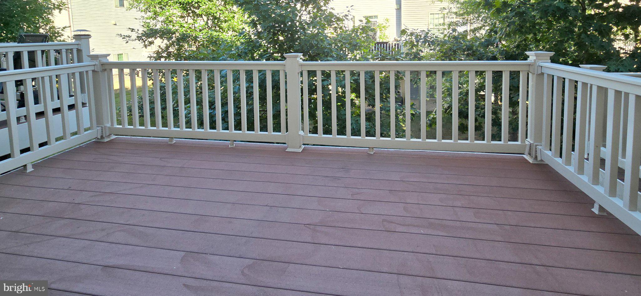 7339 Old Calvary Road Hanover, MD 21076 - Photo 22 of 22 Spacious deck surrounded by greenery.