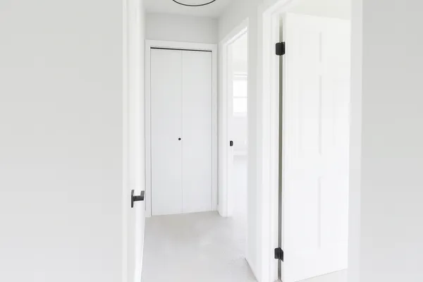 a bathroom with a granite countertop double vanity sink mirror and toilet