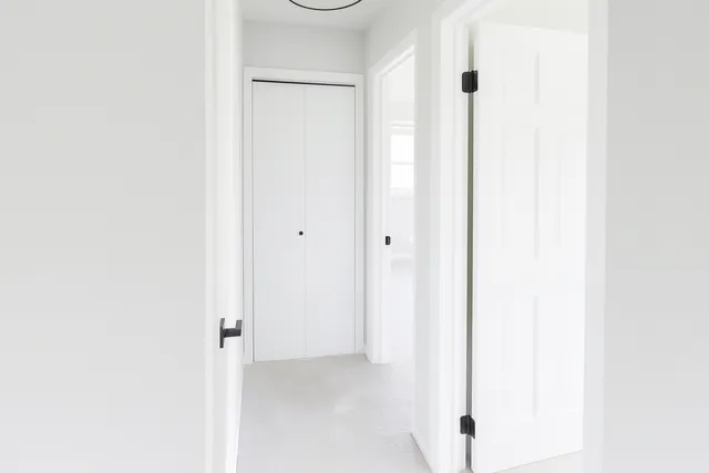 a bathroom with a granite countertop double vanity sink mirror and toilet