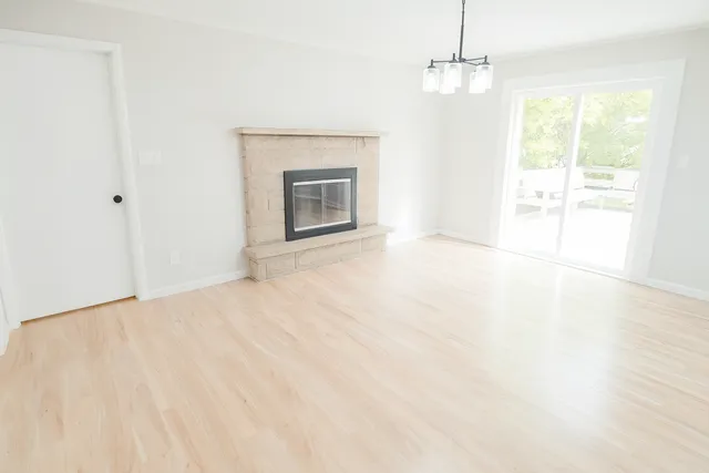 a view of empty room with a fireplace