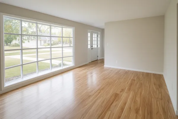 wooden floor in an empty room with a window