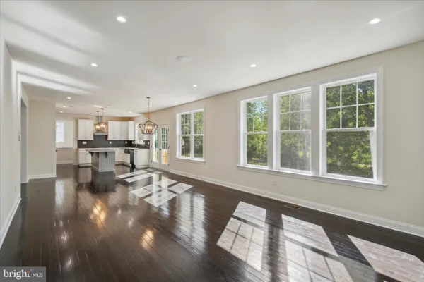 a view of a living room and dining room with a floor to ceiling window