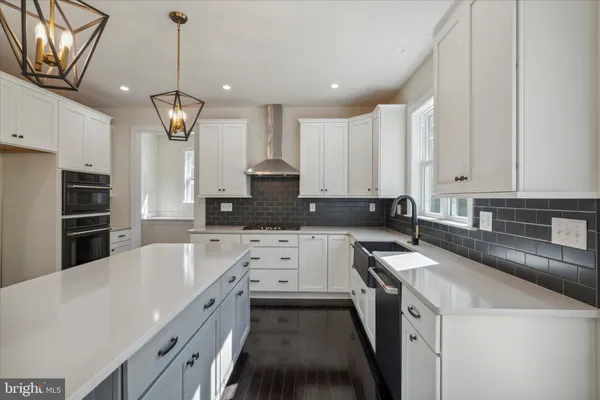 a kitchen with stainless steel appliances granite countertop a sink a stove and a refrigerator