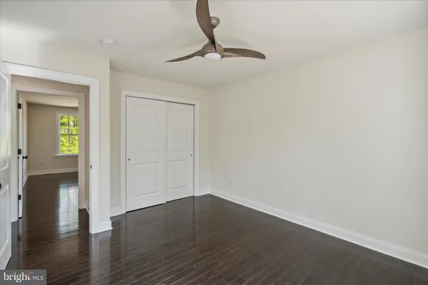 a view of a room with wooden floor and glass door