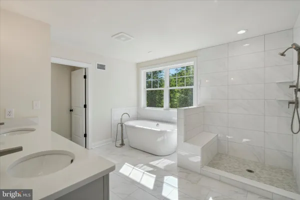 a bathroom with a tub sink and window