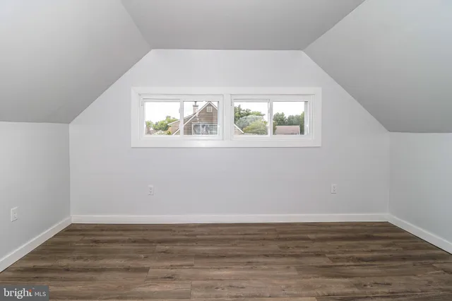 a view of room with window and wooden floor