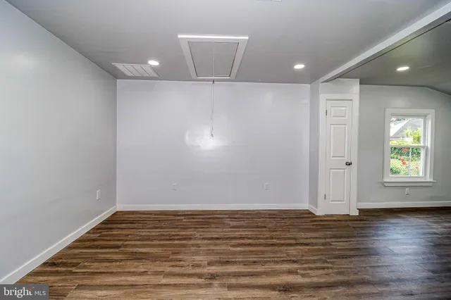 a view of room with window and wooden floor