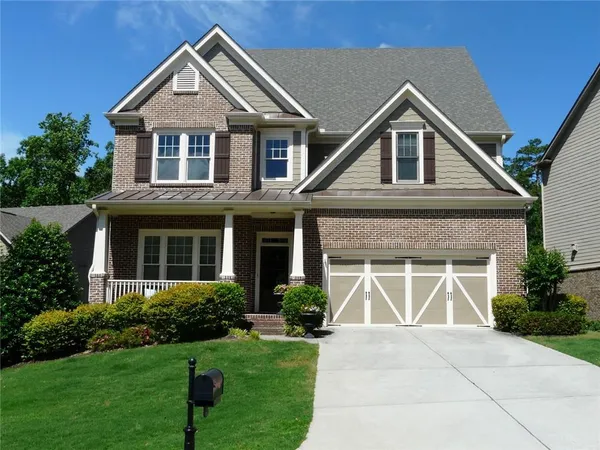 a front view of a house with garden