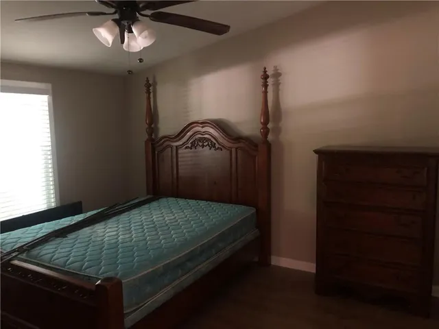 a bedroom with a bed and a dresser