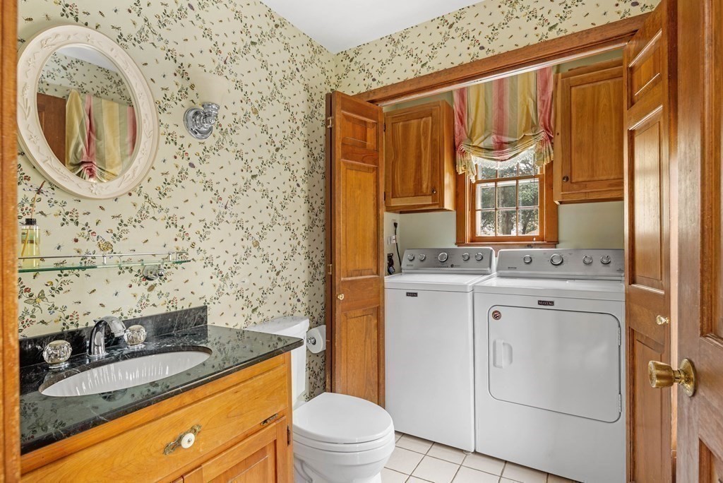 607 Broadway Hanover, MA 02339 - Photo 11 of 41 a bathroom with a granite countertop sink and a mirror