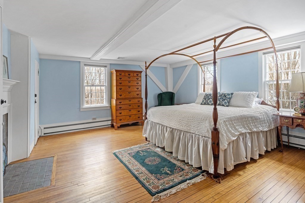 607 Broadway Hanover, MA 02339 - Photo 21 of 41 a bedroom with a bed a mirror and a window