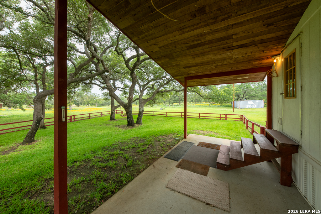 104 Longhorn Road Stockdale, TX 78160 - Photo 14 of 47 a view of backyard with a table and chairs under an umbrella