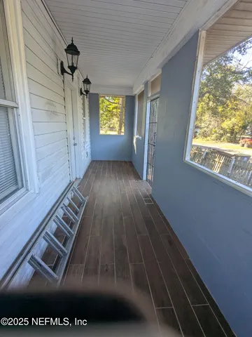 a view of an entryway with wooden floor