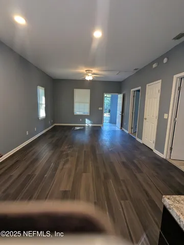 a view of an empty room and wooden floor