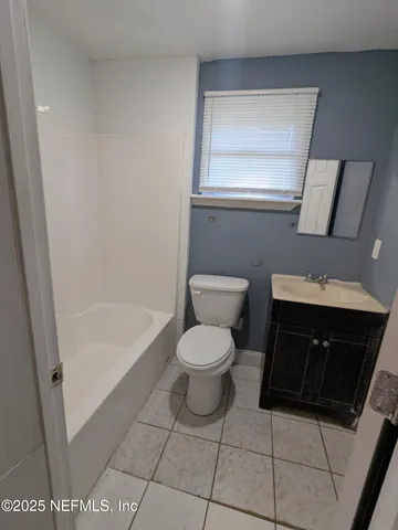 a bathroom with a toilet a sink and bathtub